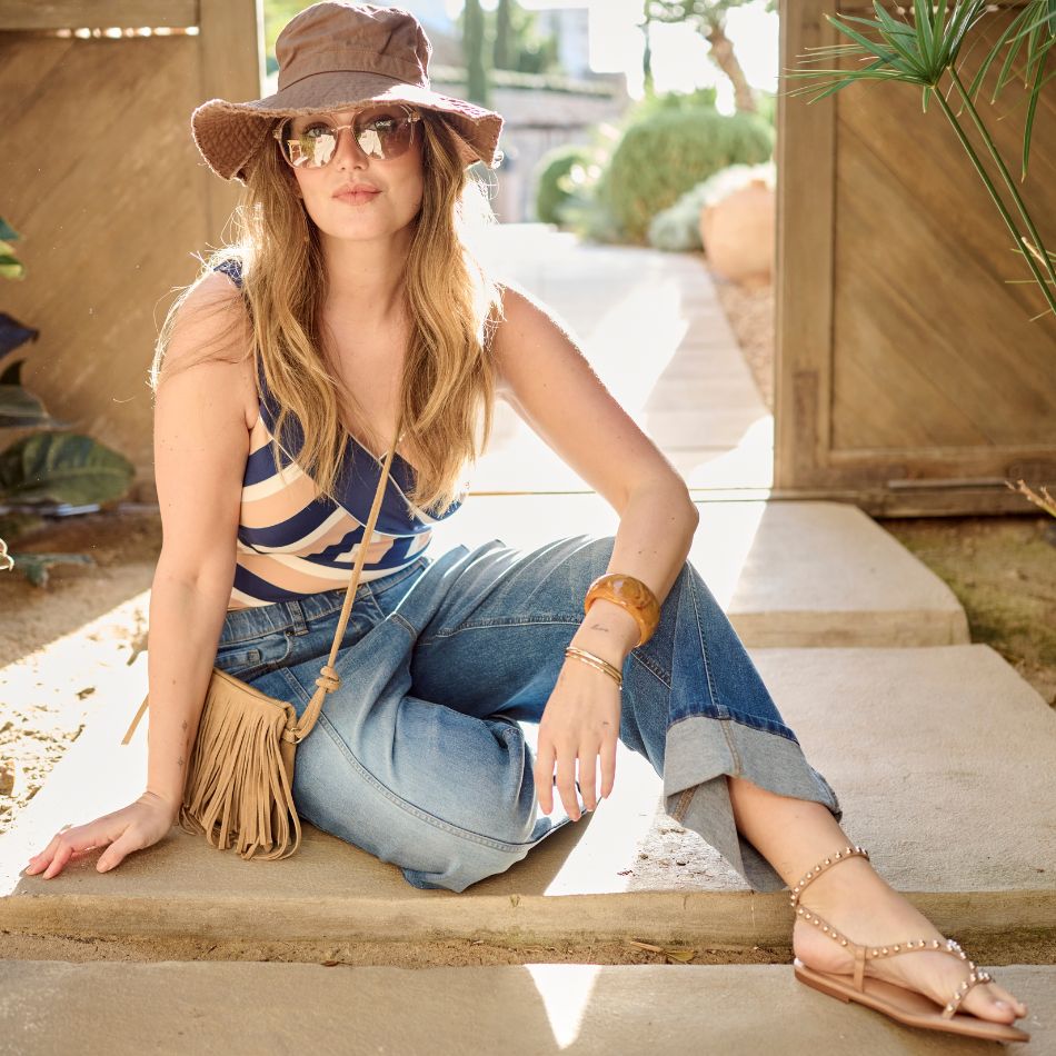 The model is posing with a swimsuit and a jeans