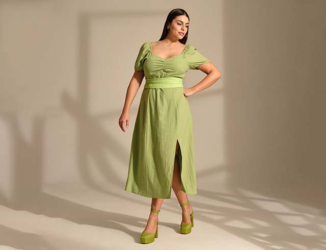 Model poses in a green dress