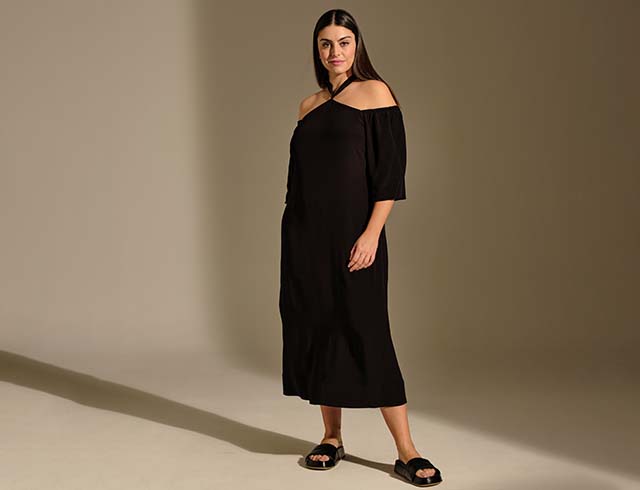 The model poses in a black dress
