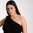 Model wears a black one shoulder knit top