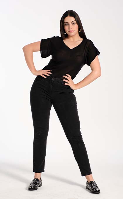 Model poses on the ground in a black linen mix t-shirt