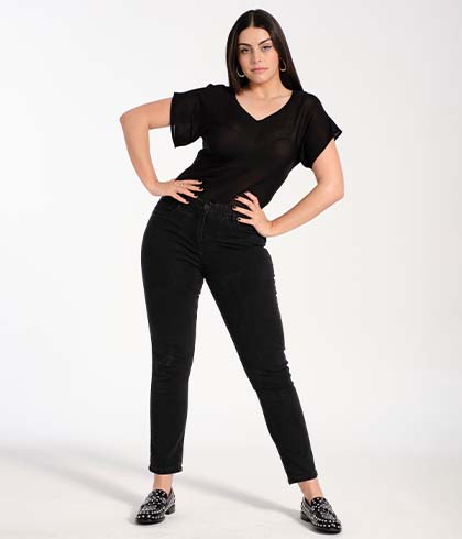 Model poses on the ground in a black linen mix t-shirt