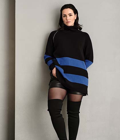 The model wears a blue and black striped jumper