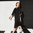 The model wears a black dress