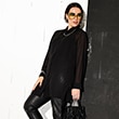 The model is wearing a black blouse