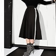 The model is wearing a skirt w