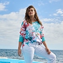The model is wearing a colourful sweatshirt