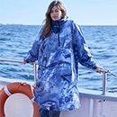 The model poses in a colorful rain cape 
