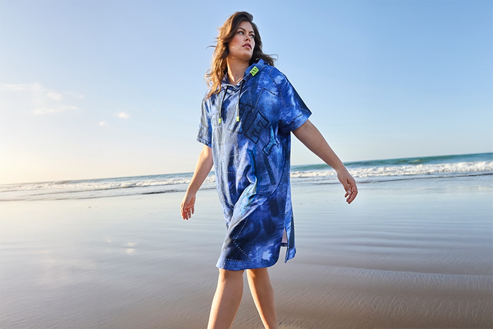 The model wears a blue beach dress