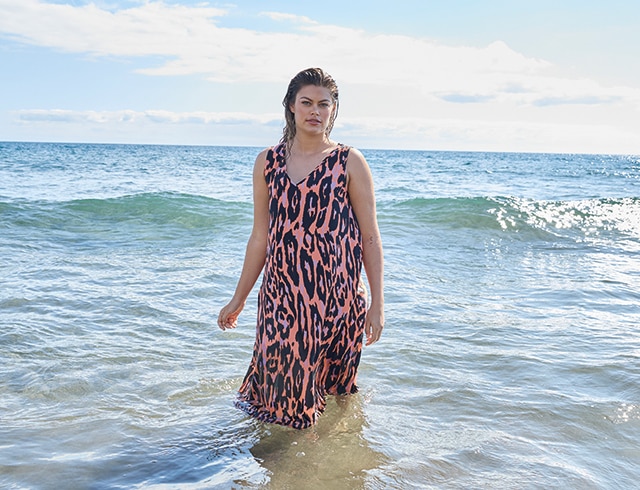 The model wears a colourful dress