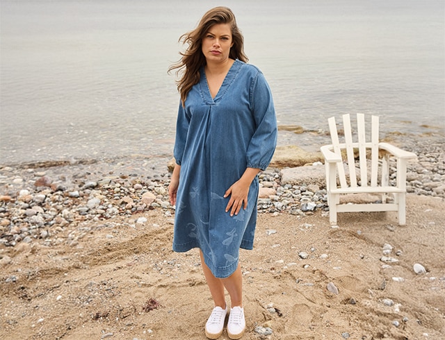 The model wears a blue dress