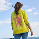 The model is wearing a colourful sweatshirt