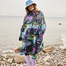 The model poses in a colorful rain cape 
