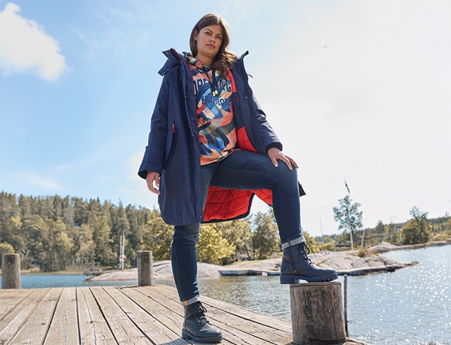 The model wears a blue dress