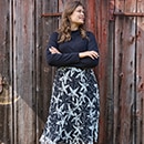 The model wears a blue dress