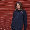 The model is wearing a colourful sweatshirt