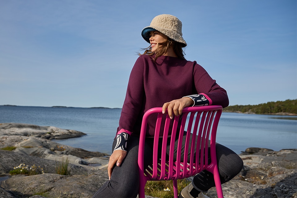 The model is wearing a blue dress