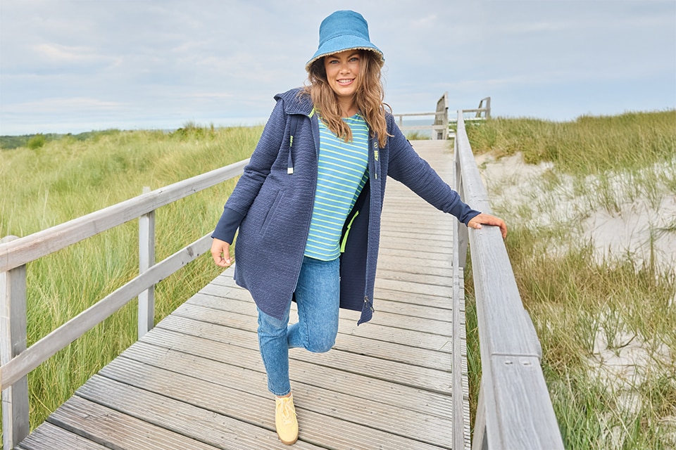 The model is wearing a white and blue striped shirt.