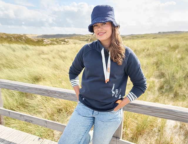 The model wears a beige sweatshirt