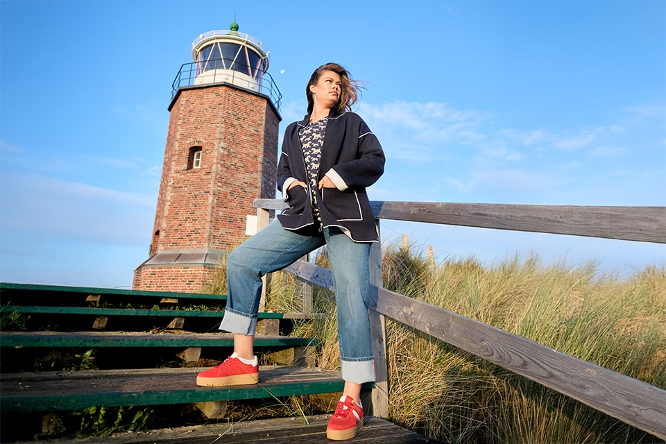 The model is wearing a blue cardigan