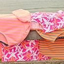 The model is wearing a quilted coat with a pattern