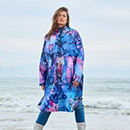 The model poses in a colorful rain cape 
