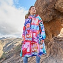 The model poses in a colorful rain cape 
