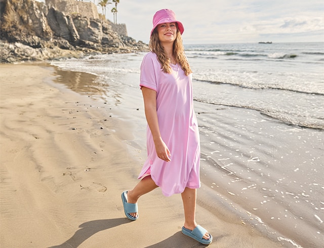 The model wears a pink dress