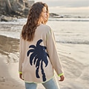 The model is wearing a printed sweater