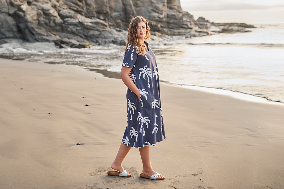 The model is wearing a blue dress