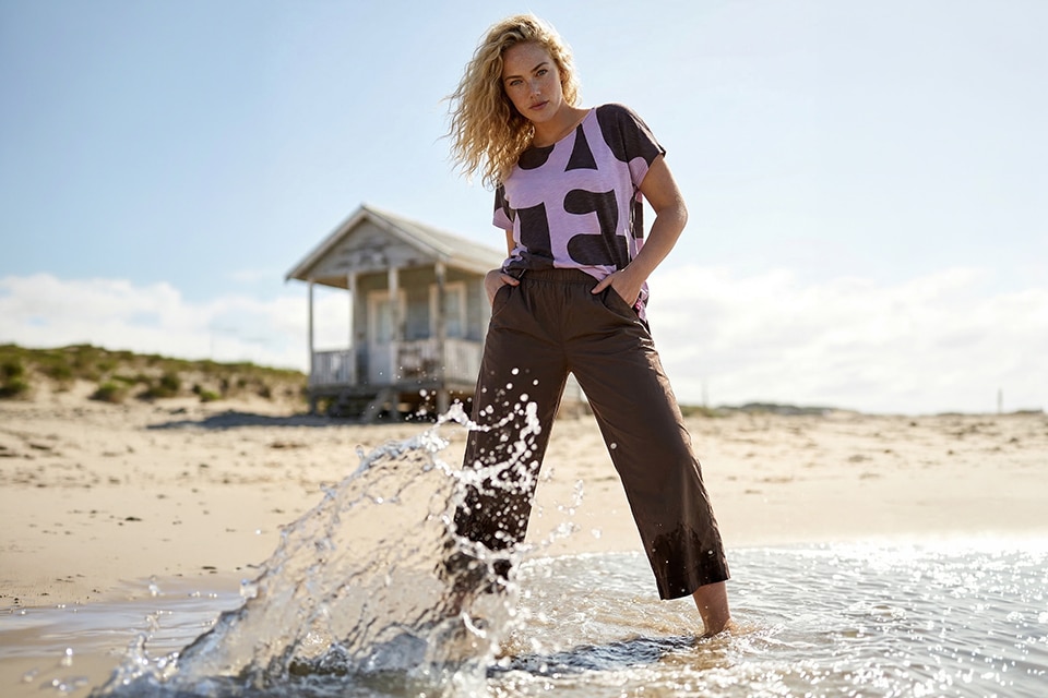 The model is wearing a shirt and a brown pants