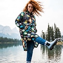 The model poses in a colorful rain cape 
