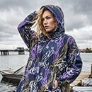 The model poses in a colorful rain cape 
