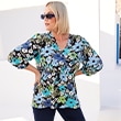 The model poses in a colorful blouse