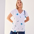 The model is wearing a white shirt with a print