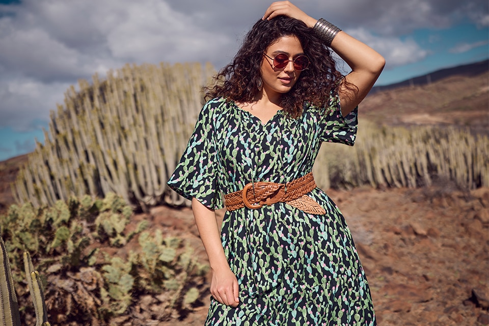 The model wears a patterned dress