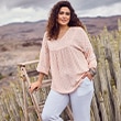 The model wears a blouse