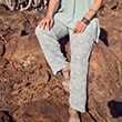 The model wears patterned trousers