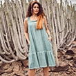 The model wears a green dress