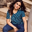 The model wears a blue shirt with patterns