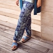 The model wears patterned trousers