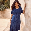 The model wears a blue dress