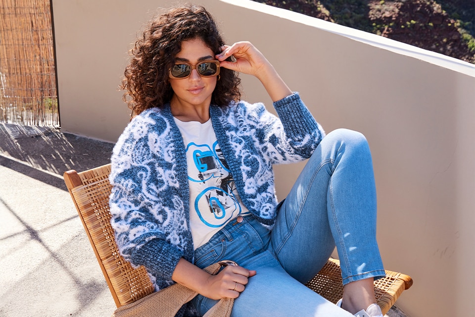 The model wears a colorful cardigan and a shirt