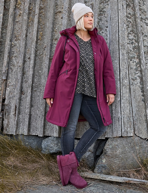 The model is waring a blue shirt and a beige cardigan 
