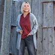 The model wears a blue cardigan