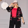 The model is wearing a Christmas-patterned cardigan.