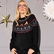 The model is wearing a jumper with a Christmas pattern.