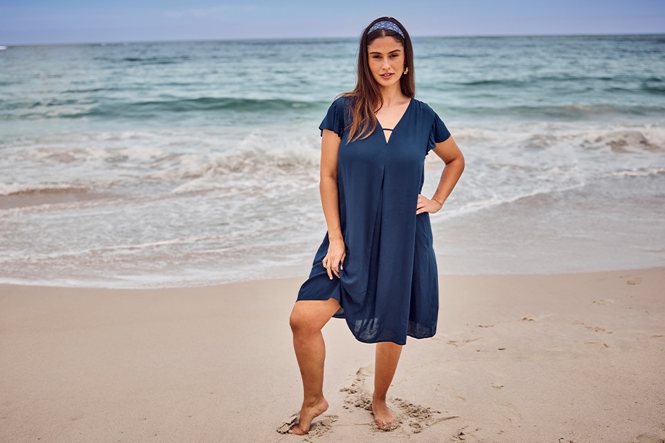 The model is wearing a navy blue dress.