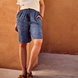 The model is wearing short, blue patterned pants.