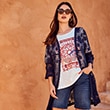 The model is wearing a dark blue cardigan.